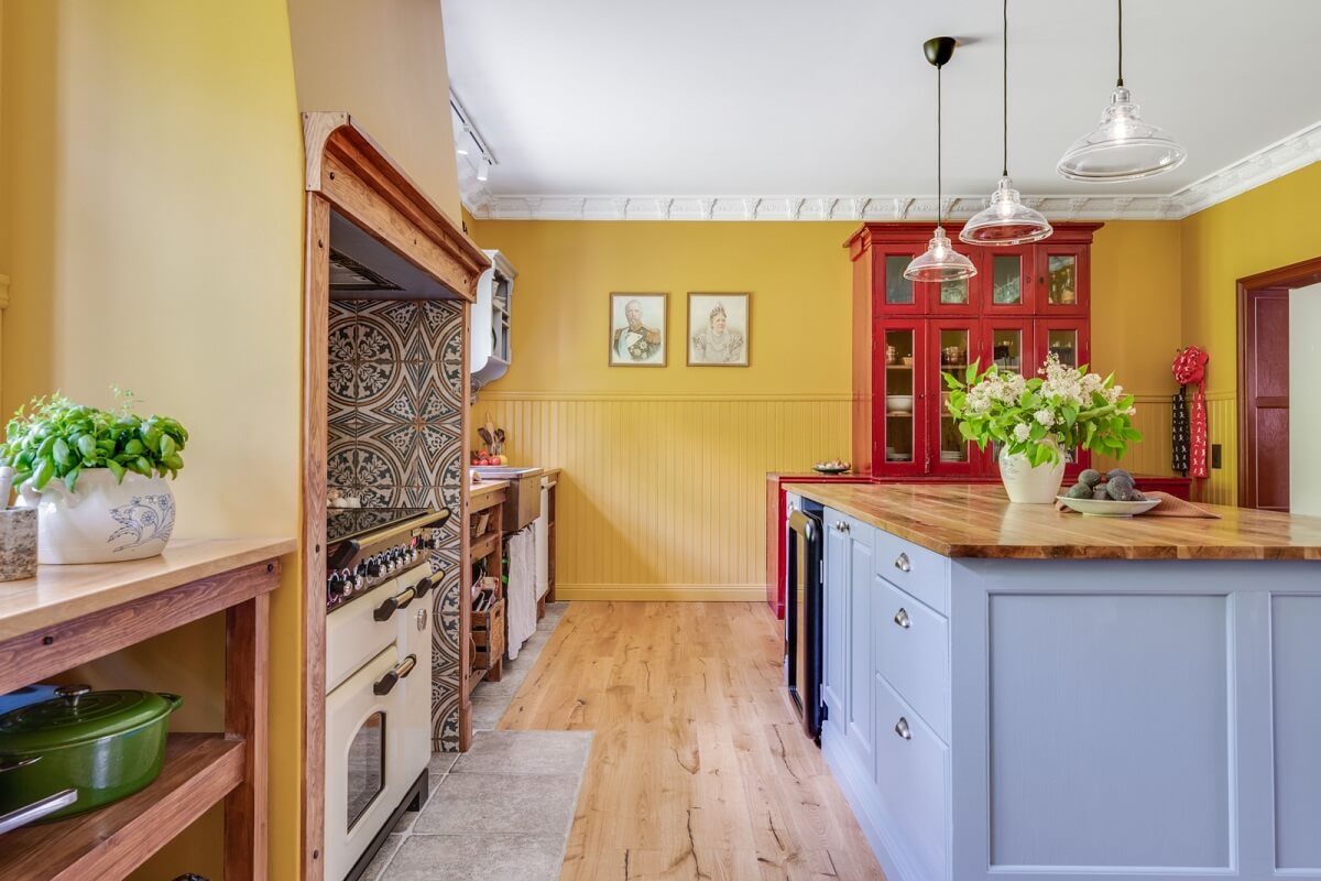 A Colorful Family Home in a Former School Building 9 kitchen-yellow-walls-light-blue-kitchen-island-nordroom