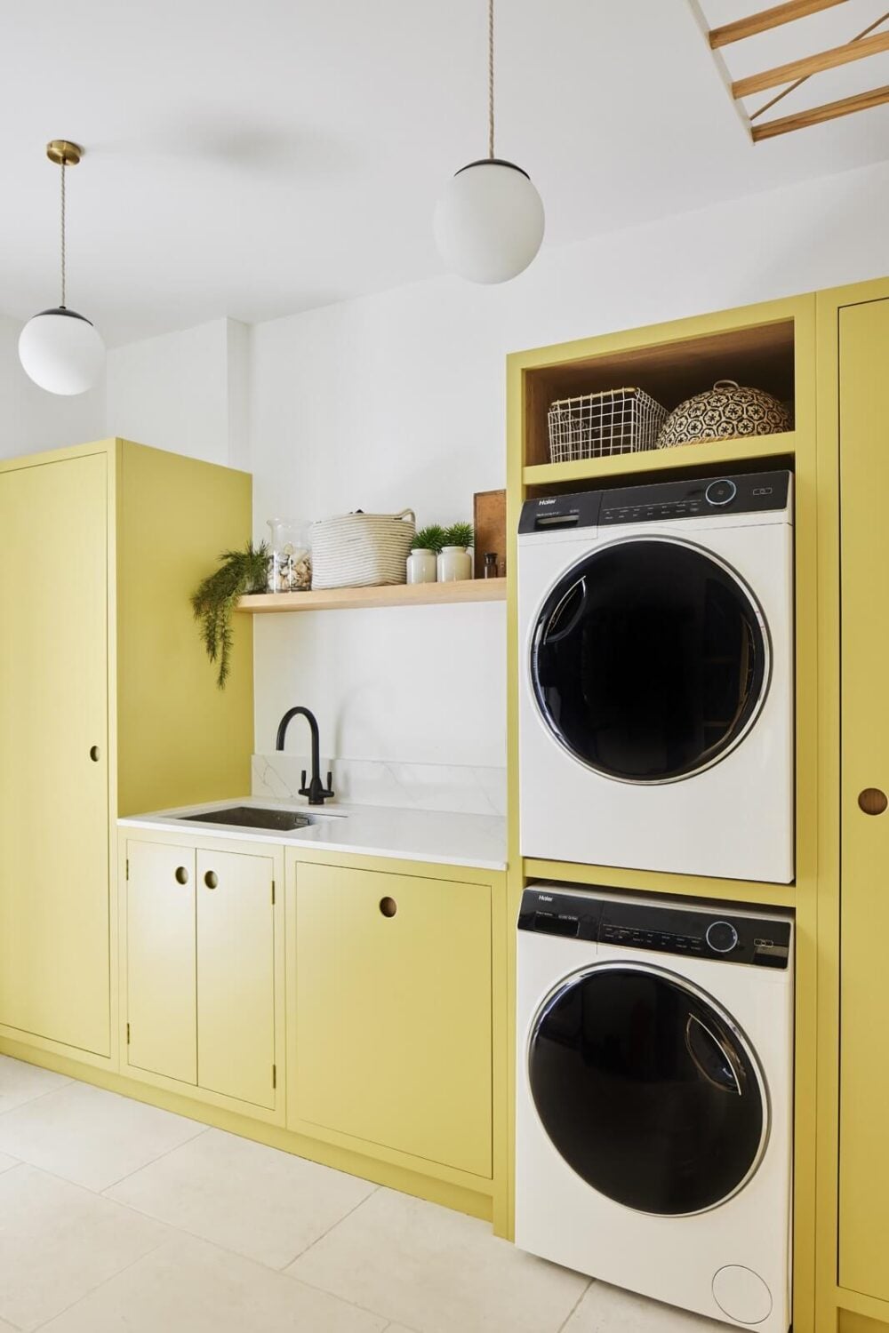 An Arts and Crafts House with Colorful Rooms 14 laundry-room-yellow-cabinets-nordroom