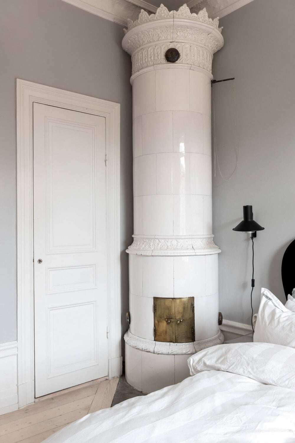 A Nordic Home with Blue Sitting Room and Kitchen 21 light-gray-bedroom-fireplace-kakelugn-nordroom