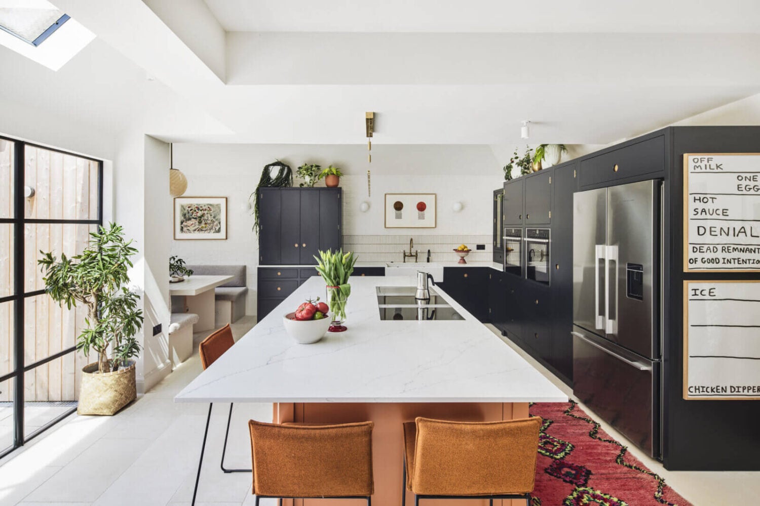 An Arts and Crafts House with Colorful Rooms 7 light-kitchen-extension-island-pink-rug-blue-kitchen-cabinets-nordroom
