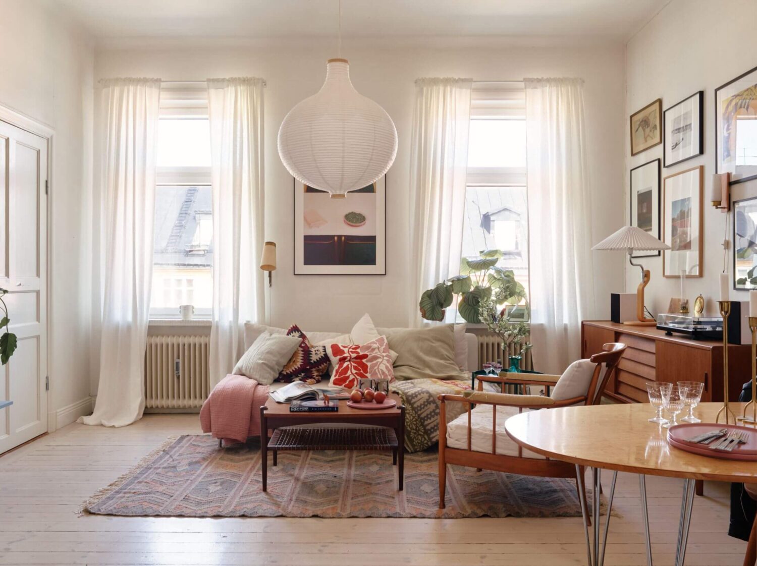 A Charming Apartment with Muted Blue Bedroom 6 light-nordic-sitting-room-gallery-wall-nordroom