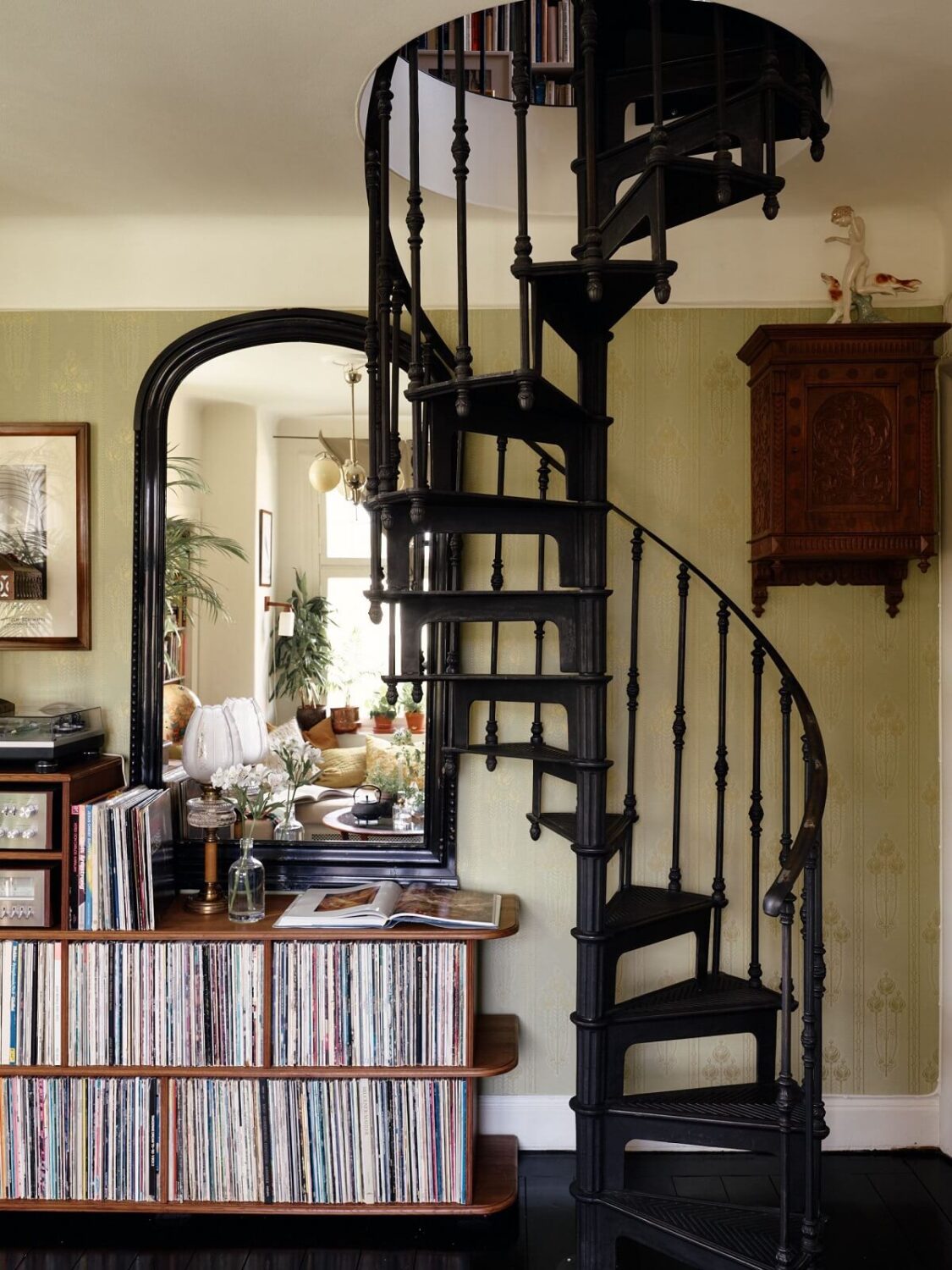 A Cozy Vintage Bohemian Maisonette in Sweden 10 living-room-black-floor-spiral-staircase-nordroom