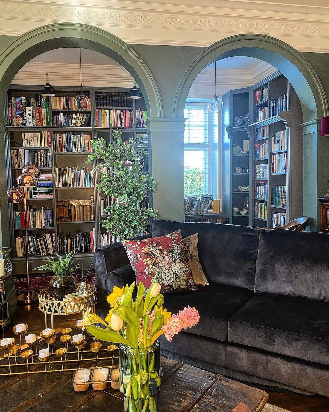 A Wonderful Eclectic Maximalist Home in England 4 living-room-green-arches-bookshelves-nordroom
