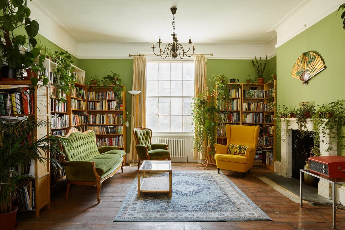 A Colorful Eclectic Home in England 3 living-room-green-walls-bookshelves-nordroom
