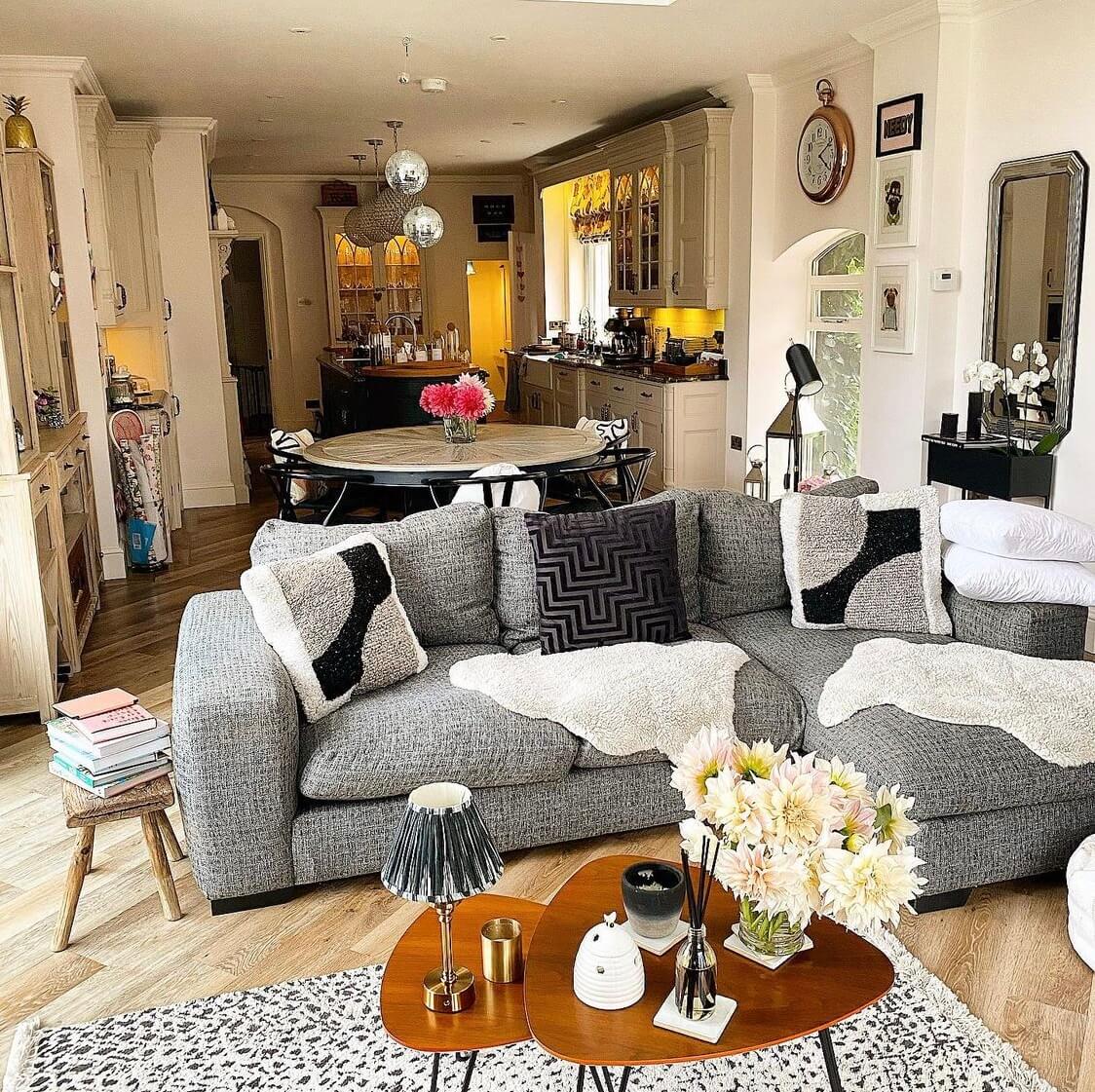 A Wonderful Eclectic Maximalist Home in England 11 open-plan-kitchen-sitting-room-round-dining-table-gray-sofa-nordroom