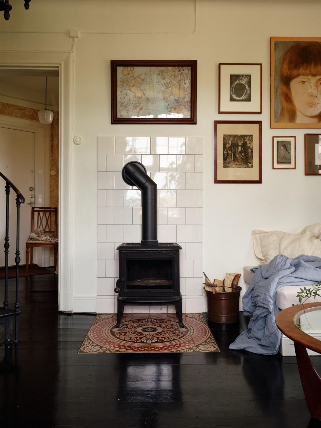 A Cozy Vintage Bohemian Maisonette in Sweden 6 sitting-room-cast-iron-stove-black-floorboards-nordroom