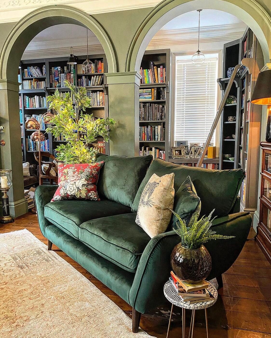 A Wonderful Eclectic Maximalist Home in England 2 sitting-room-green-sofa-arches-home-library-nordroom