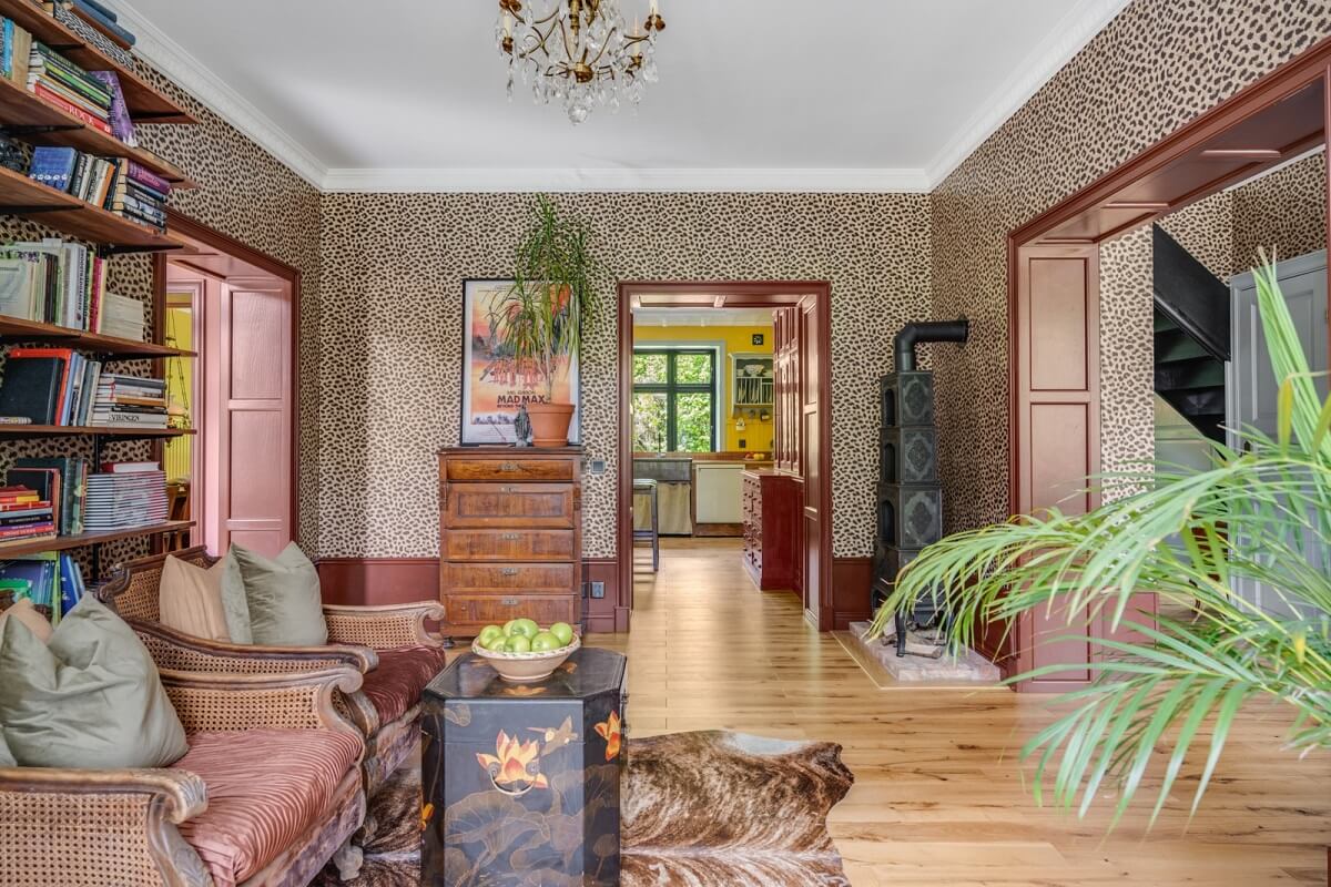 A Colorful Family Home in a Former School Building 7 sitting-room-wooden-floor-vintage-chairs-bookshelves-nordroom