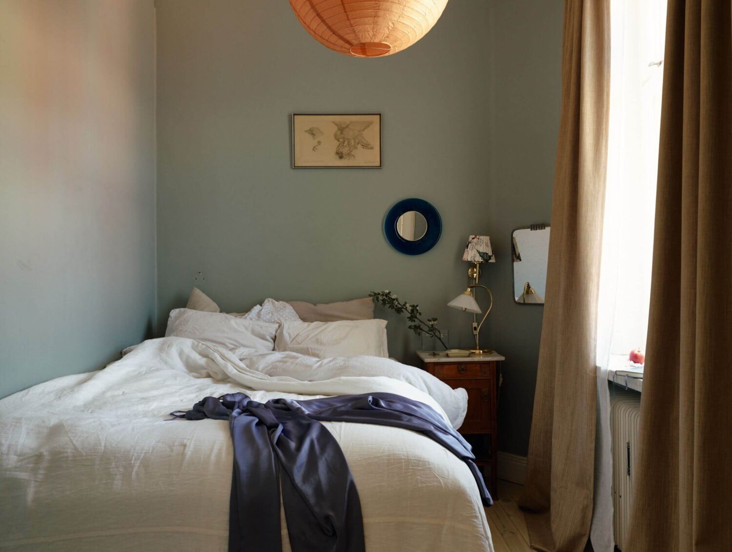 A Charming Apartment with Muted Blue Bedroom 12 small-bedroom-muted-blue-walls-antique-nightstand-nordroom