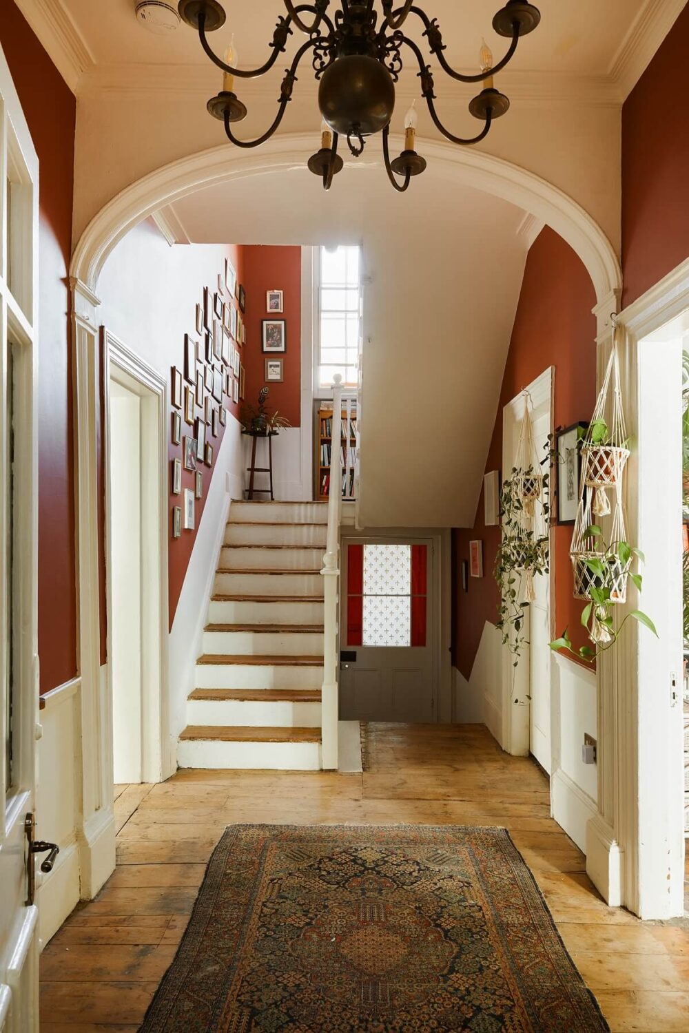 A Colorful Eclectic Home in England 22 spacious-hallway-arch-wooden-floor-staircase-nordroom