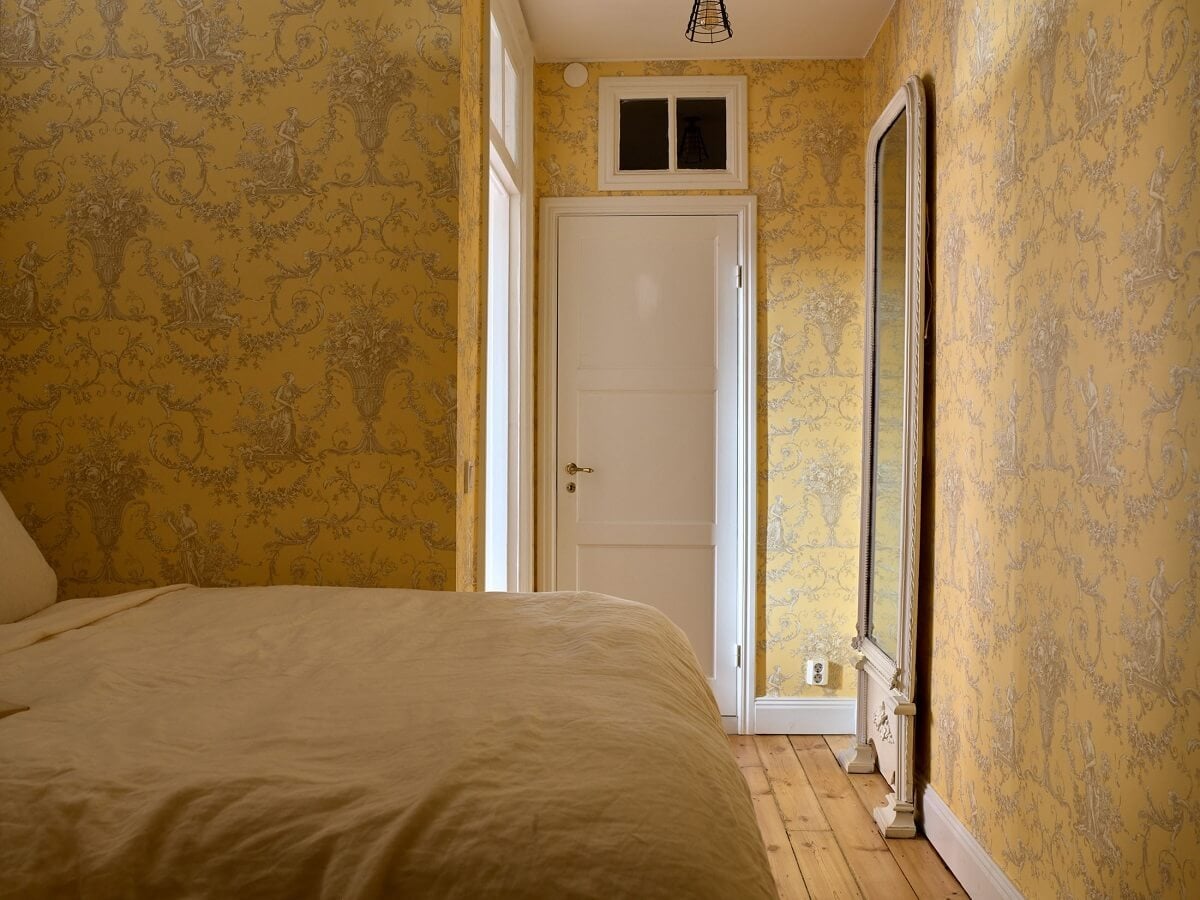A Bedroom with Yellow French Wallpaper in a Small Scandi Home 15 yellow-bedroom-French-wallpaper-large-mirror-nordroom