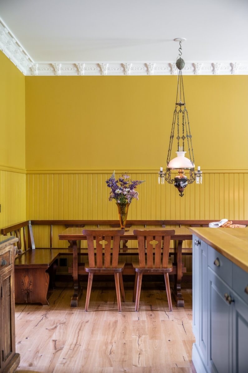 A Colorful Family Home in a Former School Building 16 yellow-walls-dining-space-wooden-bench-nordroom