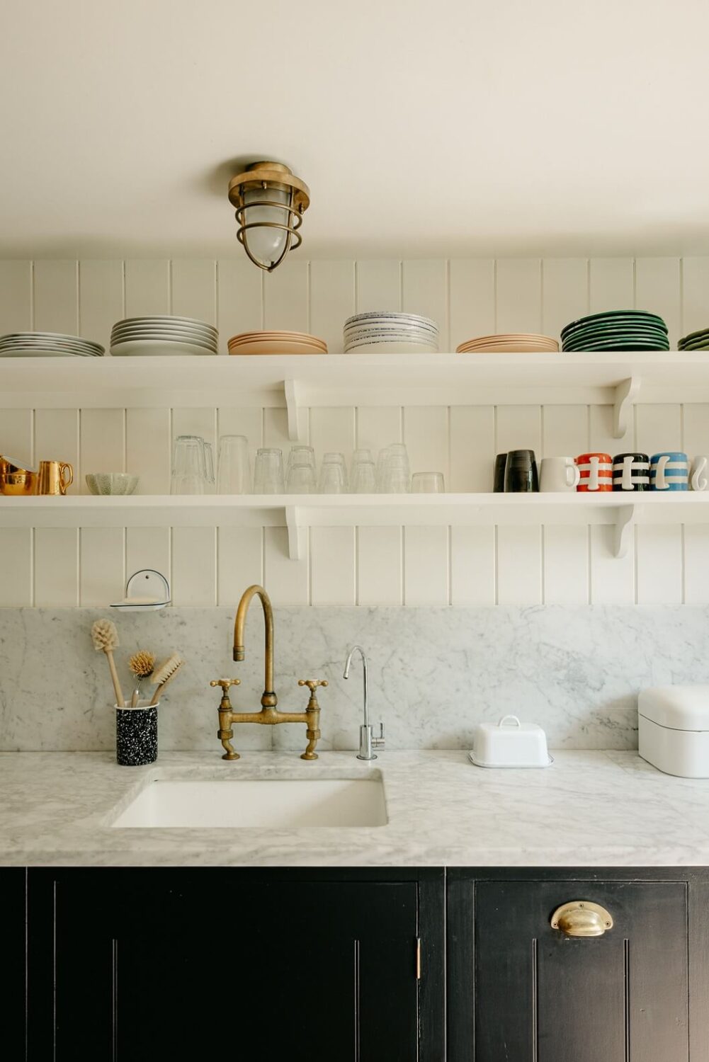 A Carefully Restored Victorian House in London 12 basement-kitchen-dark-blue-cabinets-shelves-nordroom