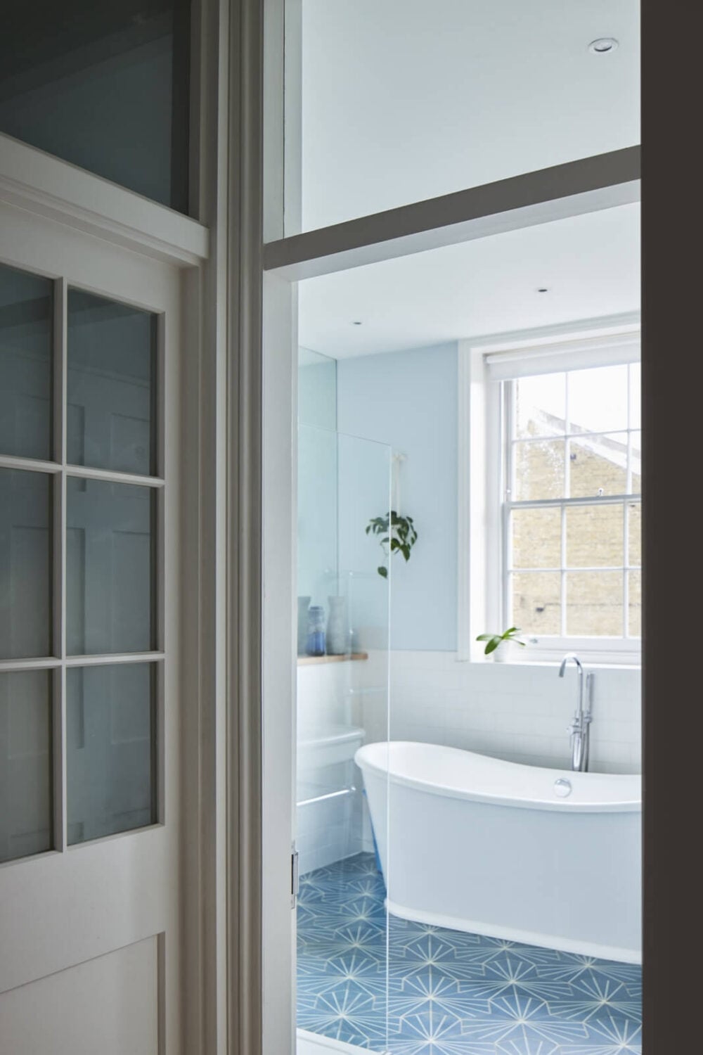 Inspiring Bathrooms With Geometric Tiles 21 bathroom-blue-floor-tiles-freestanding-bath-nordroom