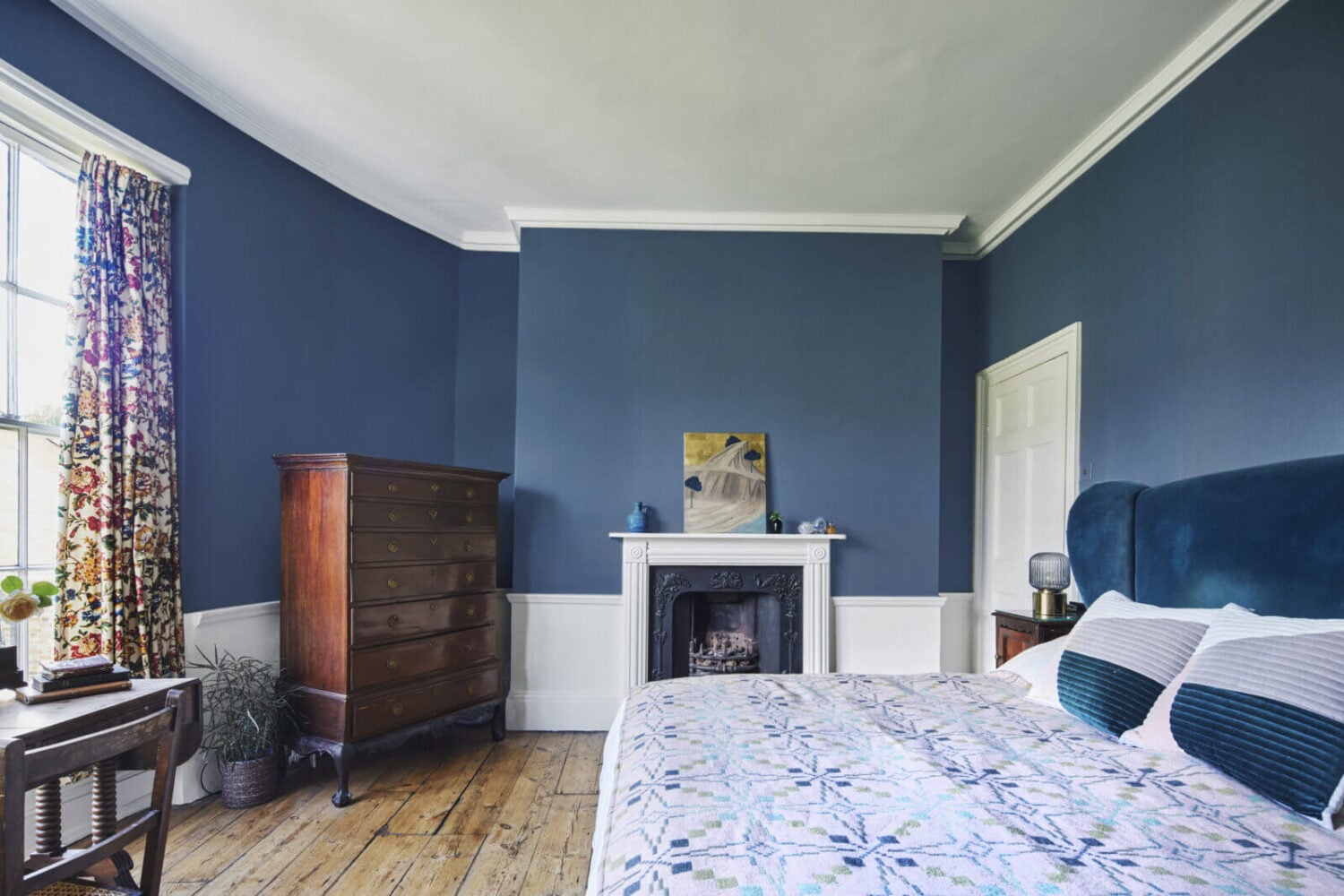 This Georgian Home in London Uses Blue as Accent Color 11 bedroom-velvet-blue-headboard-fireplace-wooden-floor-nordoom
