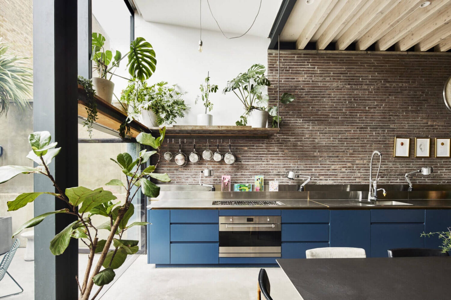 The Makers House: A Modern Achitectural Home in London 3 blue-kitchen-cabinets-brick-wall-wooden-beams-glass-wall-nordroom