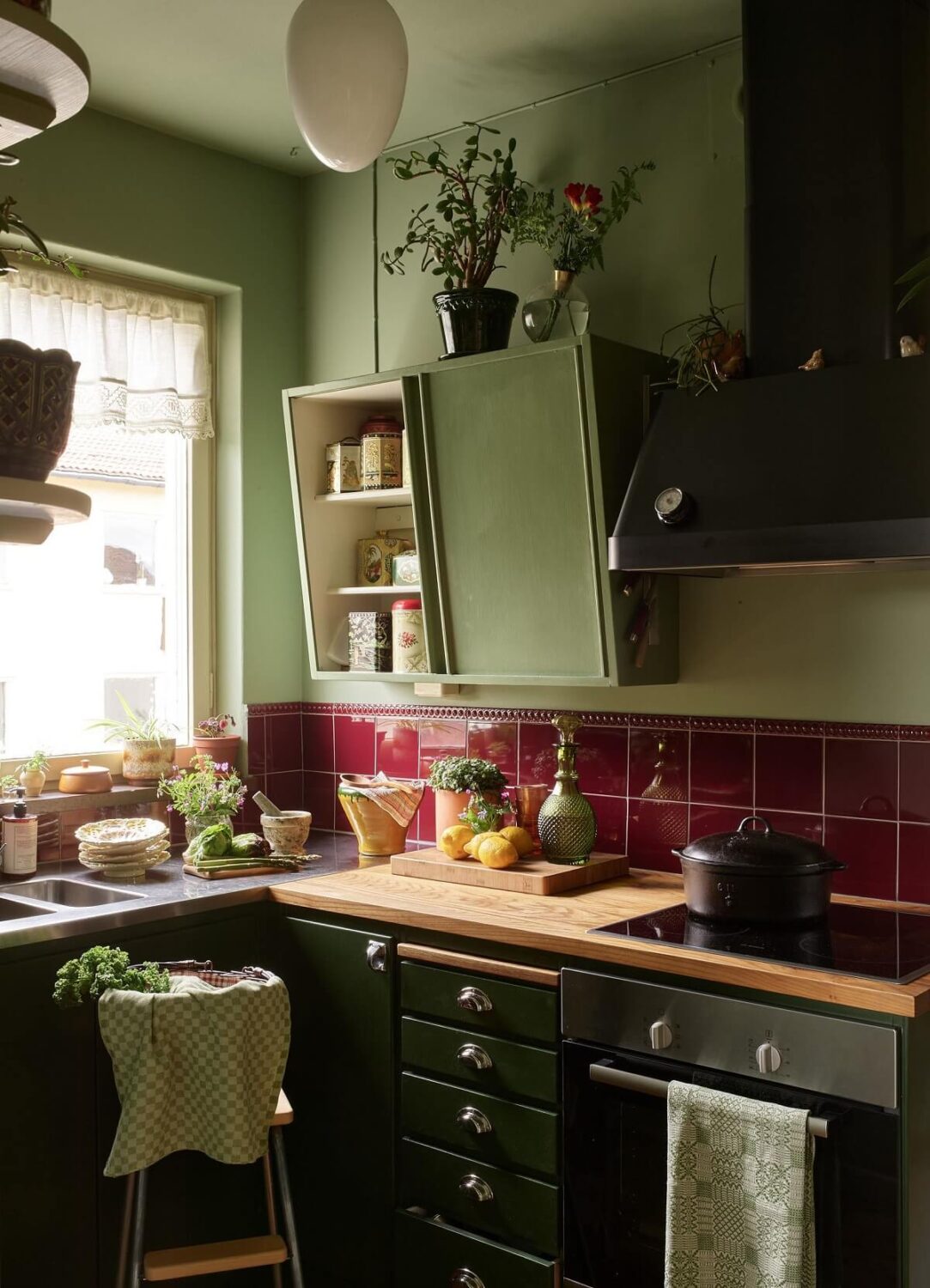57 Stylish Two-Tone Kitchen Cabinet Ideas 39 green-vintage-style-kitchen-burgundy-tiles-nordroom
