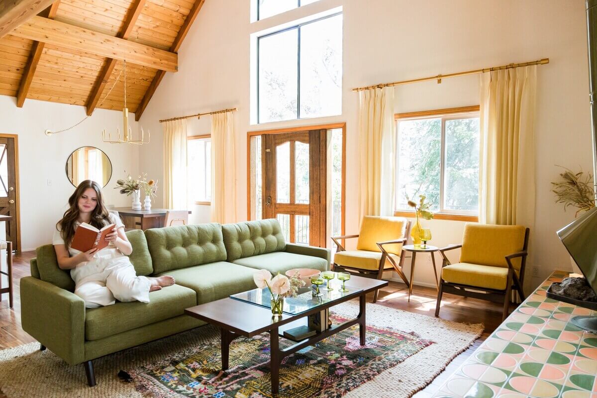 The Kitchy Cabin: A Lovely Airbnb Home in California 3 living-room-green-sofa-midcentury-yellow-armchairs-wooden-ceiling-nordroom