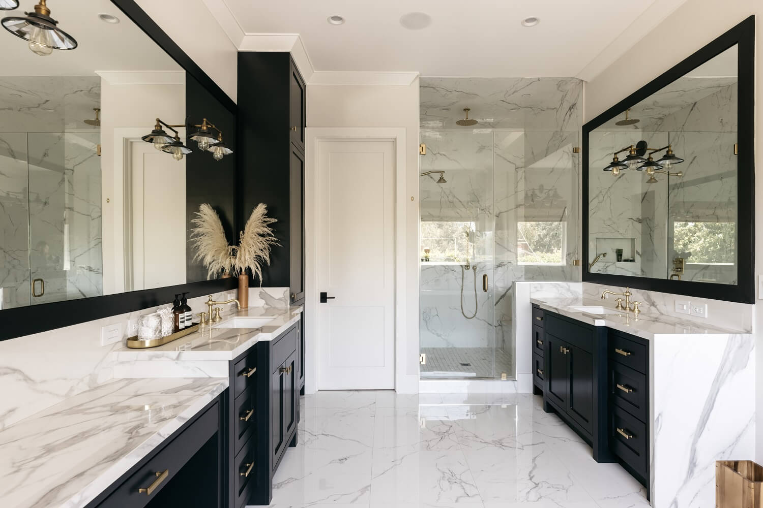 The Los Angeles Home of Emmy Raver-Lampman and Daveed Diggs 21 master-bathroom-blue-cabinets-marble-tiles-daveed-diggs-emmy-raver-lampman-nordroom