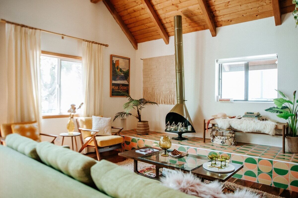 The Kitchy Cabin: A Lovely Airbnb Home in California 4 midcentury-living-room-green-sofa-colorful-tiles-fireplace-nordroom