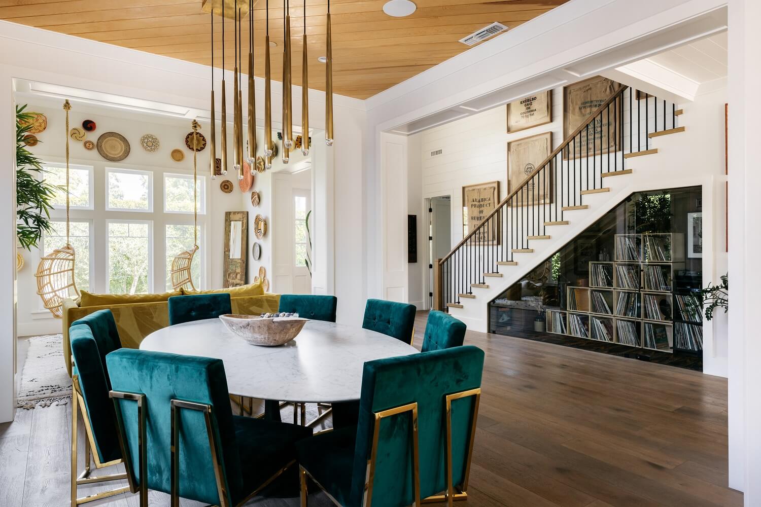 The Los Angeles Home of Emmy Raver-Lampman and Daveed Diggs 11 oval-dining-table-green-chairs-music-cabinets-daveed-diggs-emmy-raver-lampman-nordroom