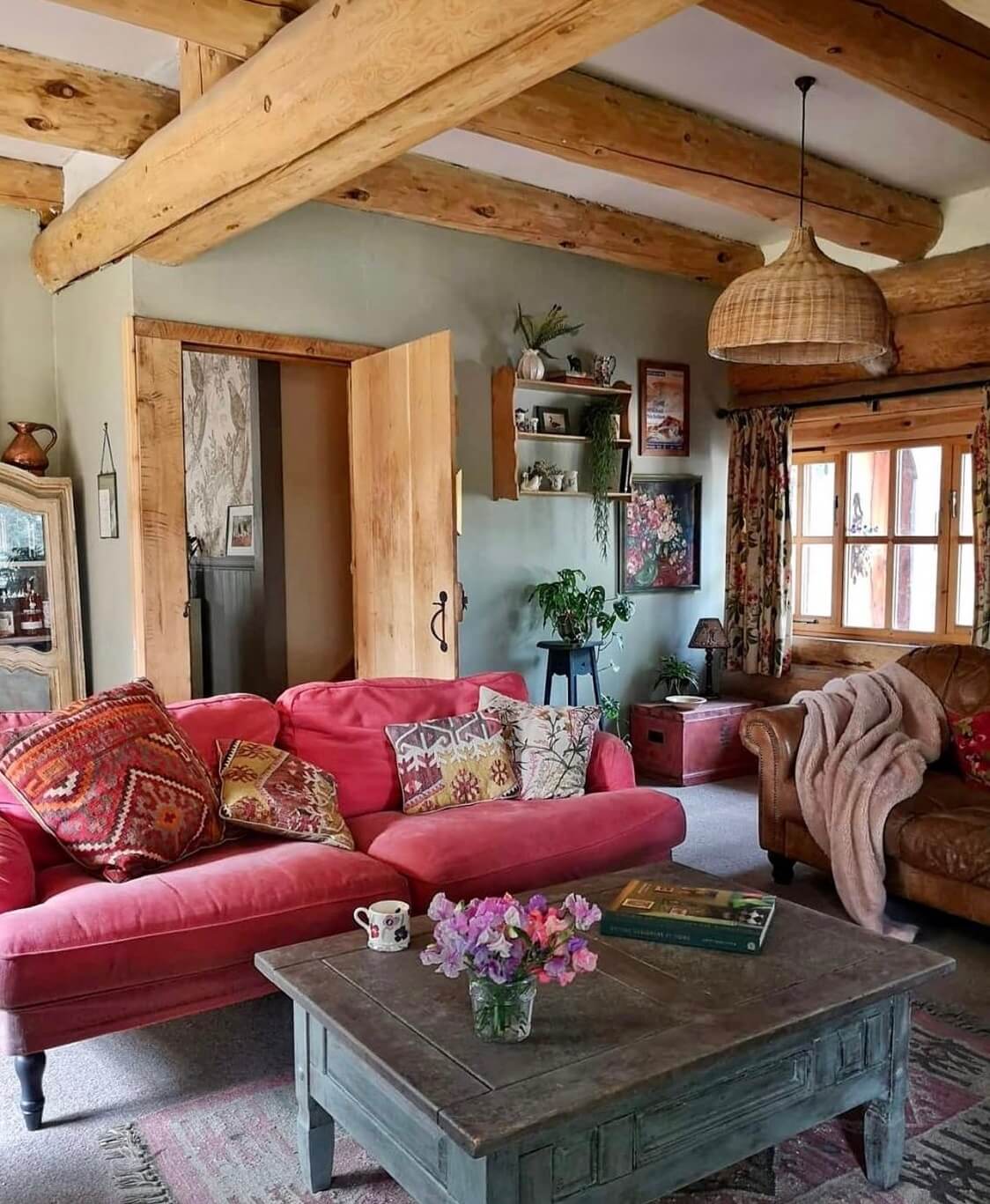 Imrich Lodge: A Cozy Self-Built Log House in the Scottish Highlands 3 pink-sofa-rustic-cozy-sitting-room-exposed-beams-nordroom