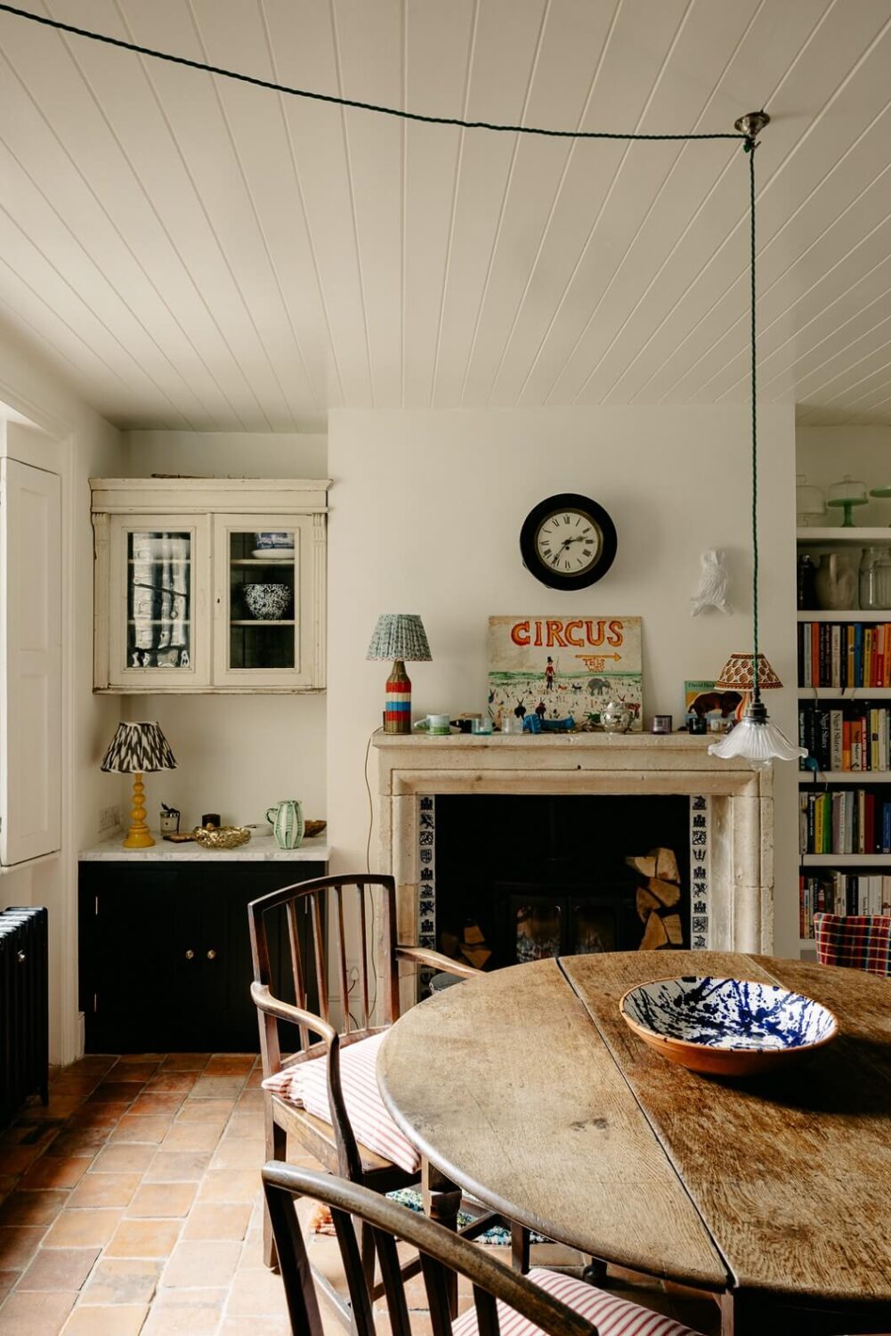 A Carefully Restored Victorian House in London 9 round-rustic-wooden-dining-table-terracotta-floor-tiles-farmhouse-style-nordroom