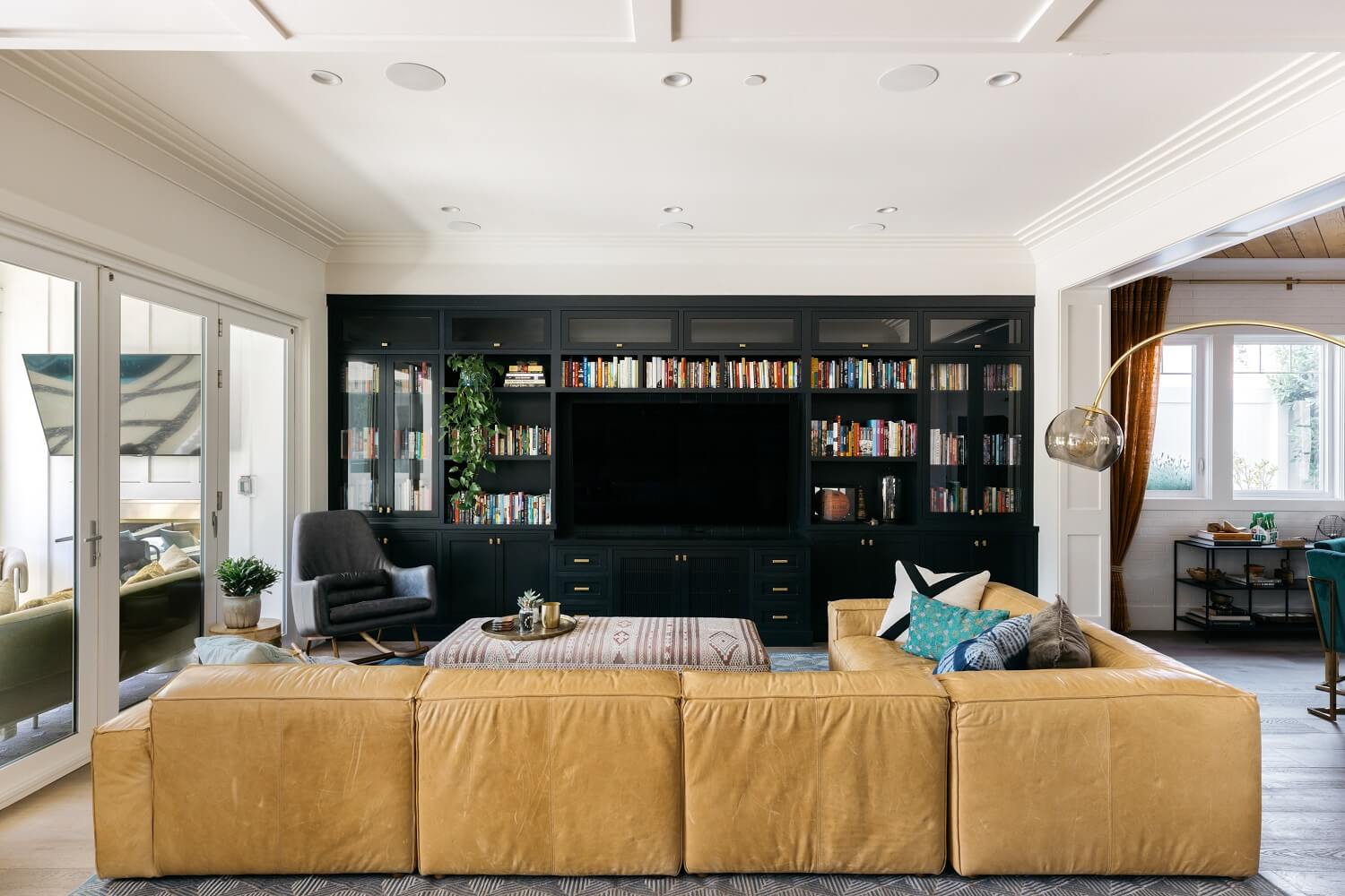 The Los Angeles Home of Emmy Raver-Lampman and Daveed Diggs 7 tv-room-corner-sofa-built-in-cabinet-daveed-diggs-emmy-raver-lampman-nordroom