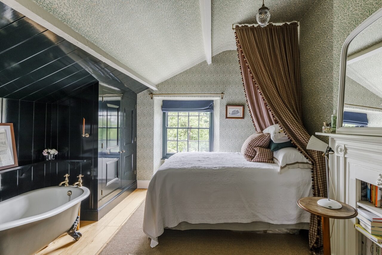A Cozy Restored Country House in England 15 bedroom-freestanding-bath-dark-blue-panels-nordroom