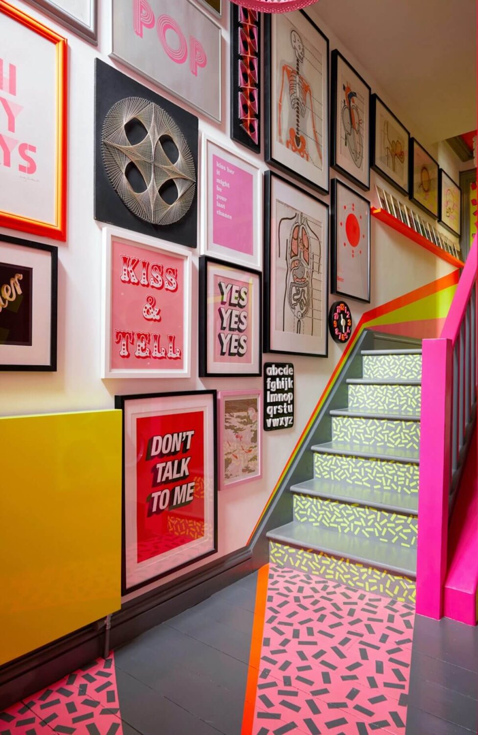 A Quirky London Home Decorated with Neon Colors 12 colorful-staircase-gallery-wall-nordroom