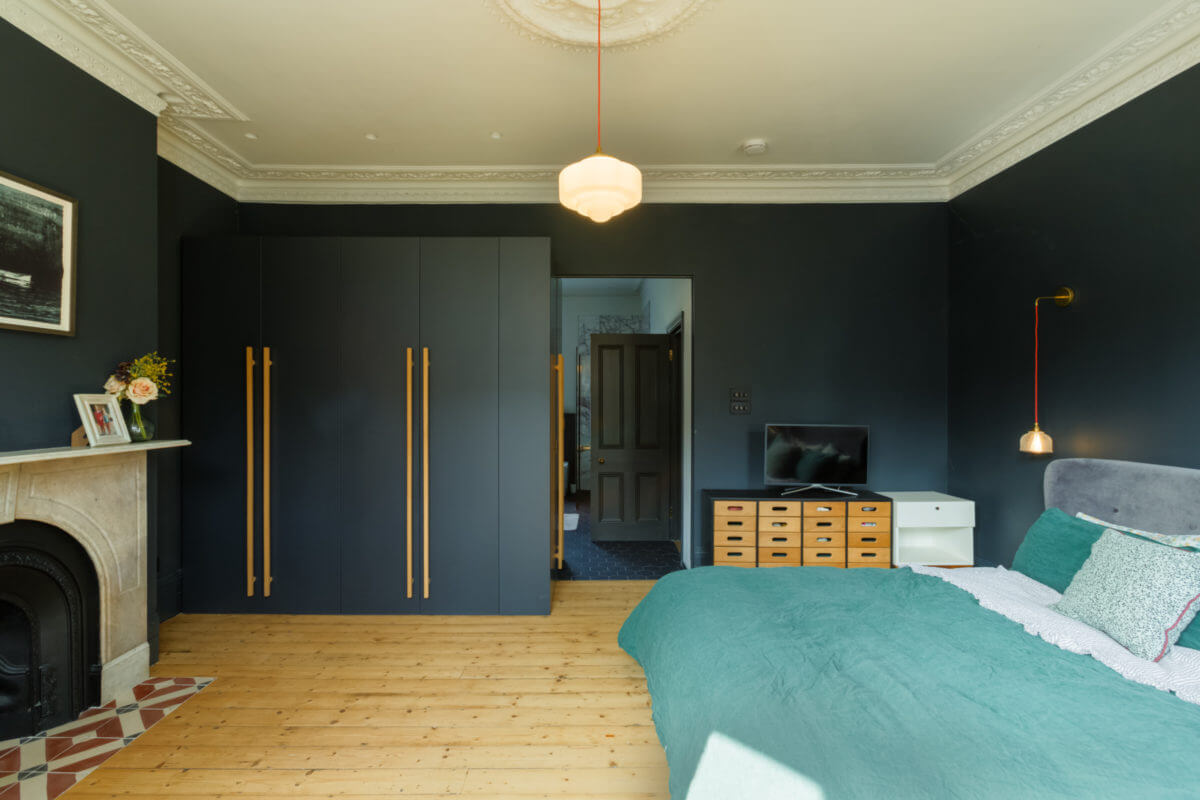 A Combination of Styles and Color in a London Townhouse 21 dark-blue-master-bedroom-wardrobes-fireplace-wooden-floor-townhouse-nordroom