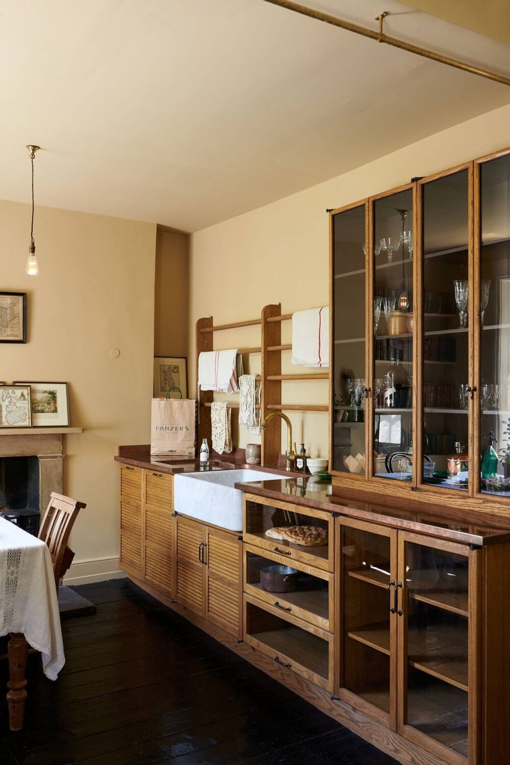 A Paint Job Transformed This deVOL Kitchen 7 devol-haberdasher-kitchen-sink-fireplace-yellow-walls-nordroom