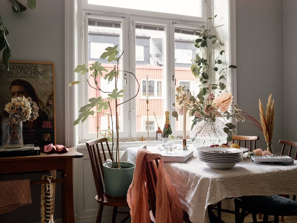 A Small Swedish Apartment with Ochre Yellow Sofa 7 dining-table-vintage-chairs-plants-nordroom