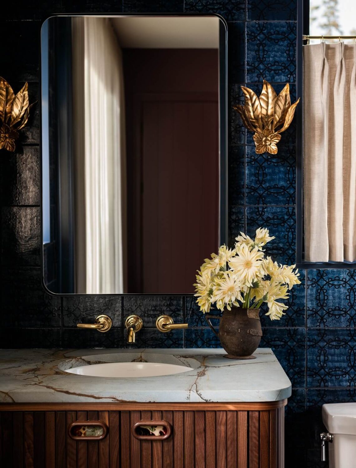 Pink Tones and Black in a Stunning Fox Island Home 22 gold-wall-sconces-blue-tiles-bathroom-retro-design-nordroom