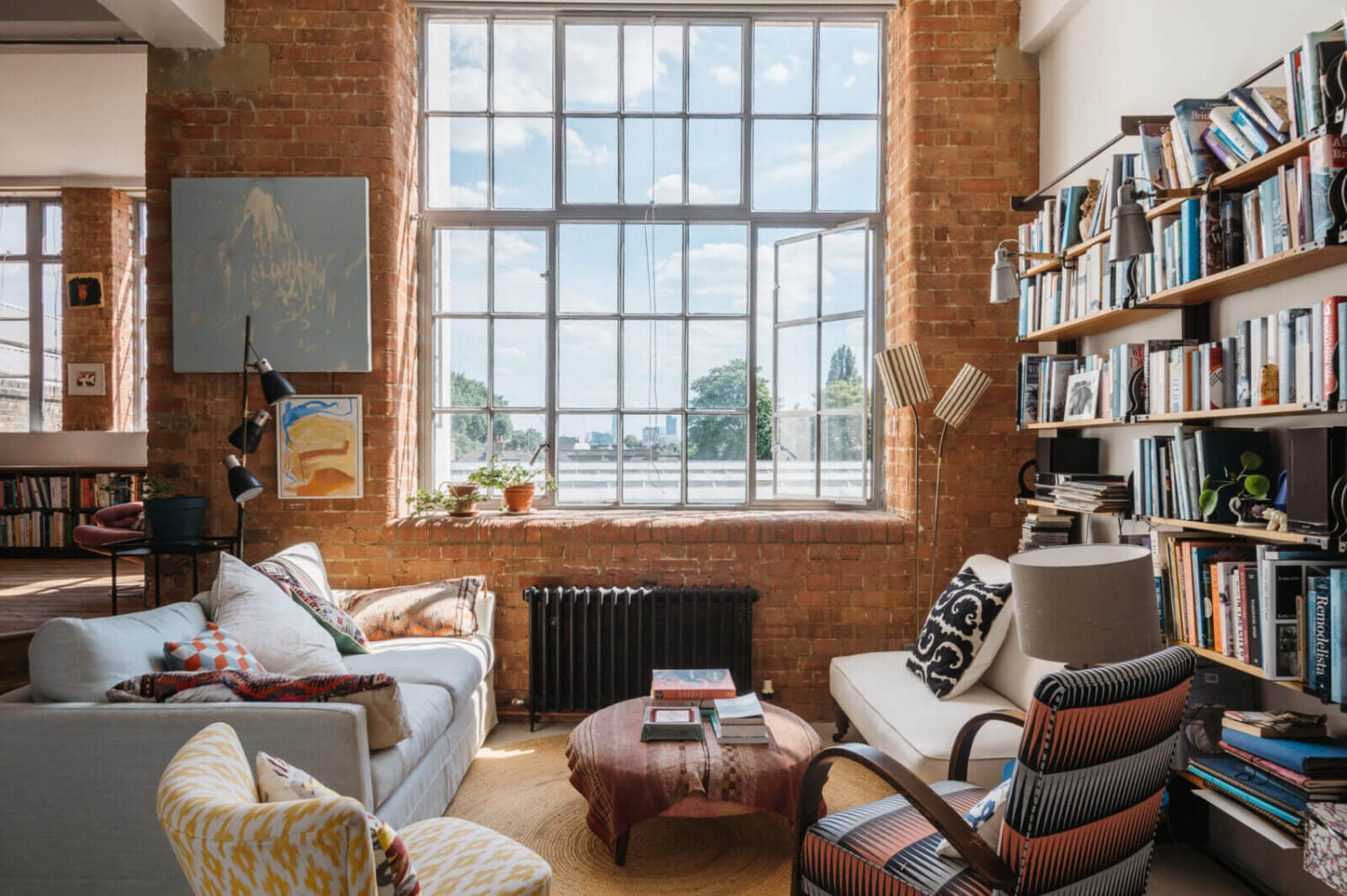 A Loft-Style Apartment with Brick Walls in London 2 loft-style-sitting-room-brick-walls-bookshelves-nordroom