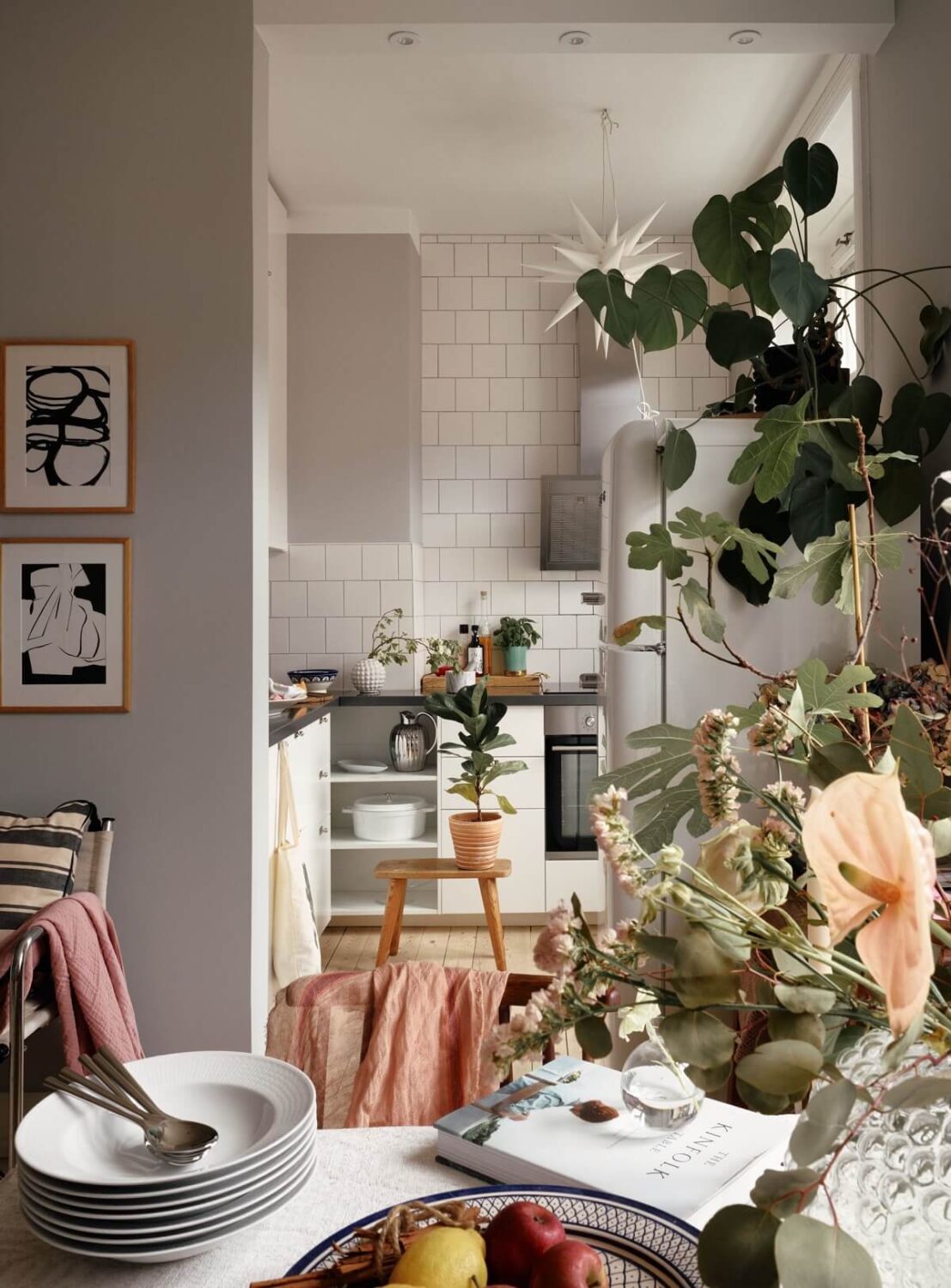 A Small Swedish Apartment with Ochre Yellow Sofa 10 open-plan-white-kitchen-nordroom