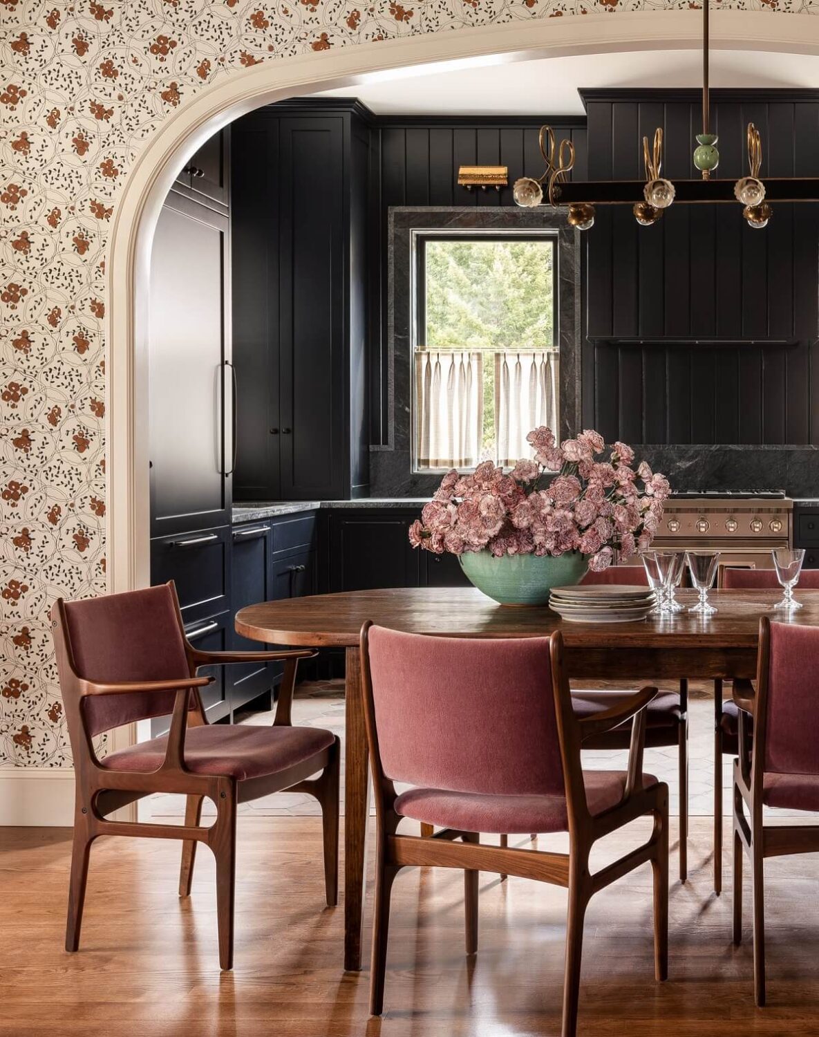 Pink Tones and Black in a Stunning Fox Island Home 1 pink-velvet-dining-chairs-kitchen-arched-doorway-wallpaper-heidi-caillier-nordroom