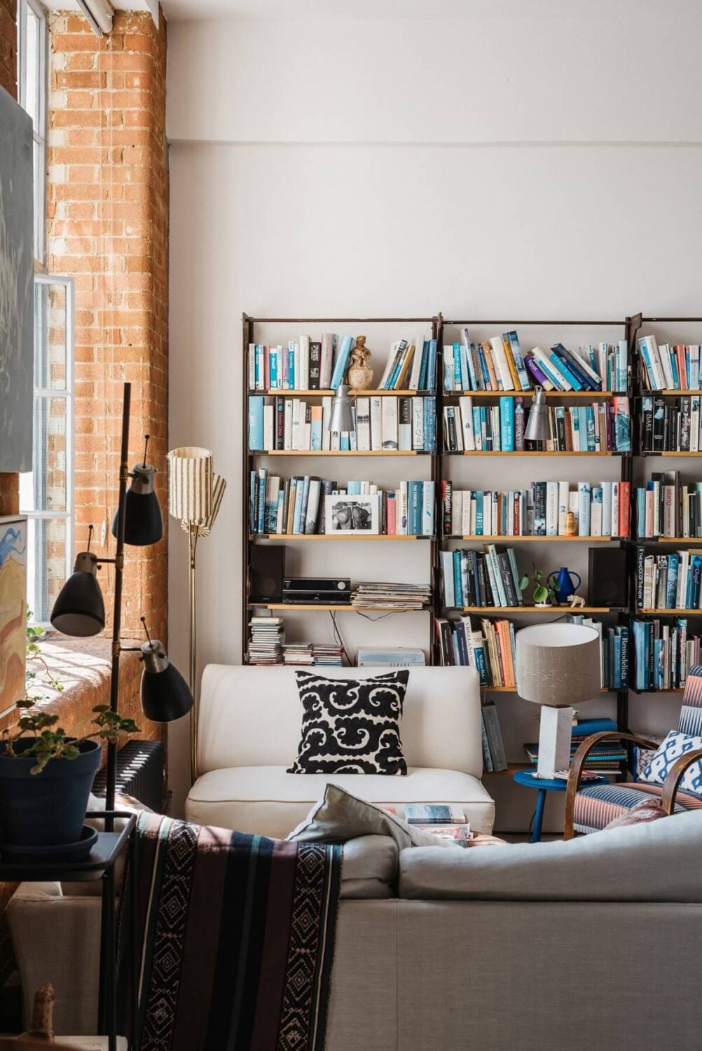 A Loft-Style Apartment with Brick Walls in London 5 sitting-room-bookshelves-white-walls-exposed-brick-london-flat-nordroom