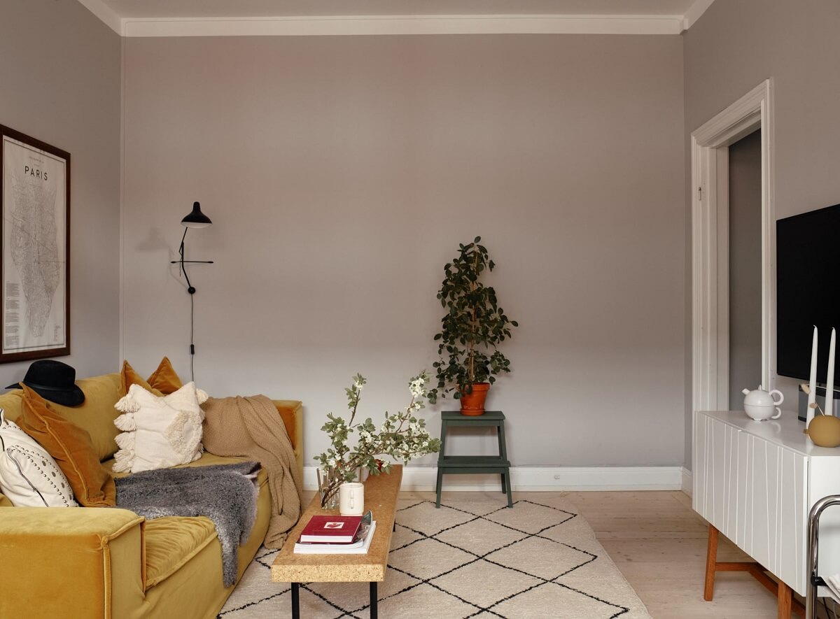 A Small Swedish Apartment with Ochre Yellow Sofa 5 sitting-room-light-gray-walls-ochre-sofa-nordroom