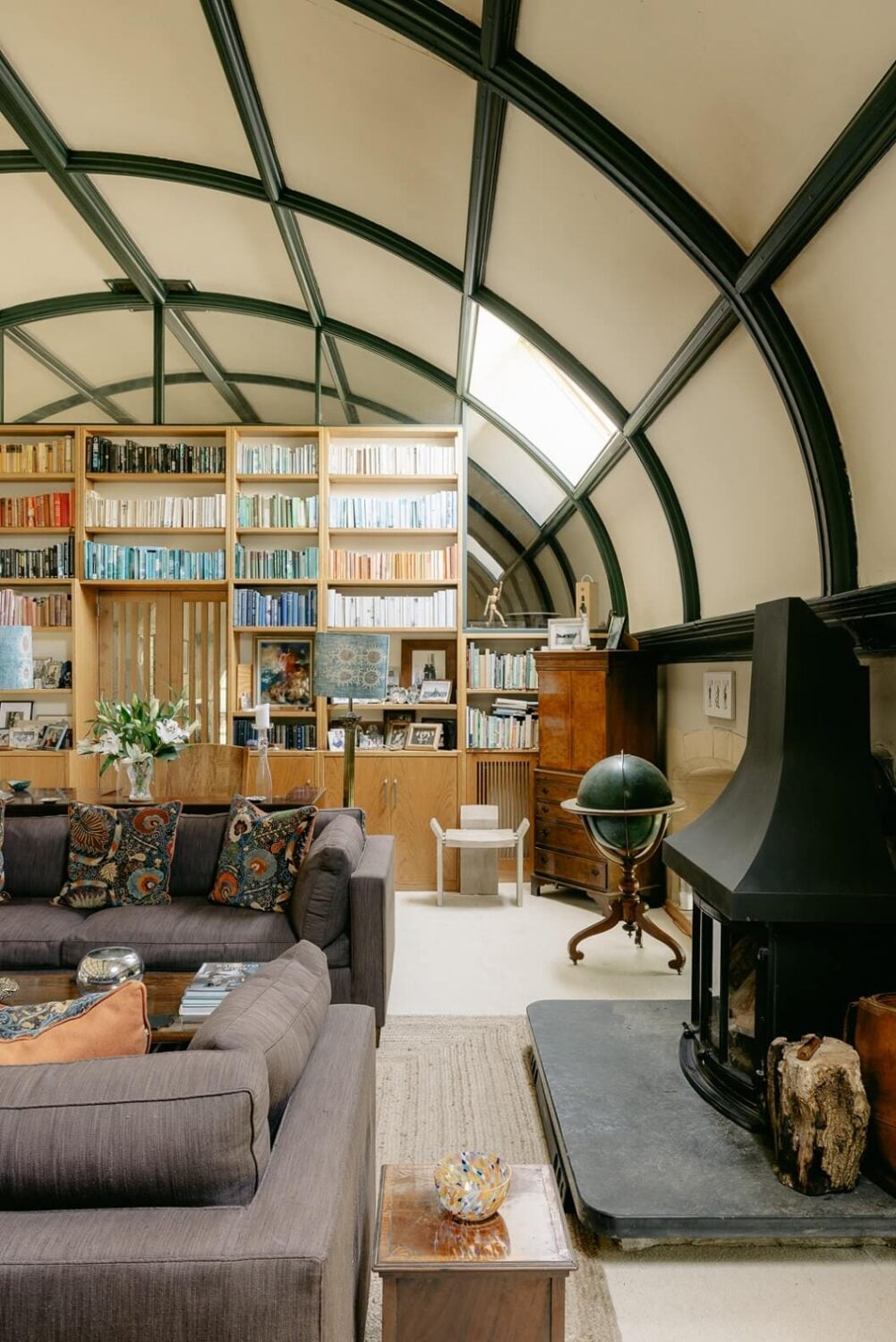 A Warm Church Conversion in England 2 sitting-room-rounded-ceiling-fireplace-bookshelves-nordroom