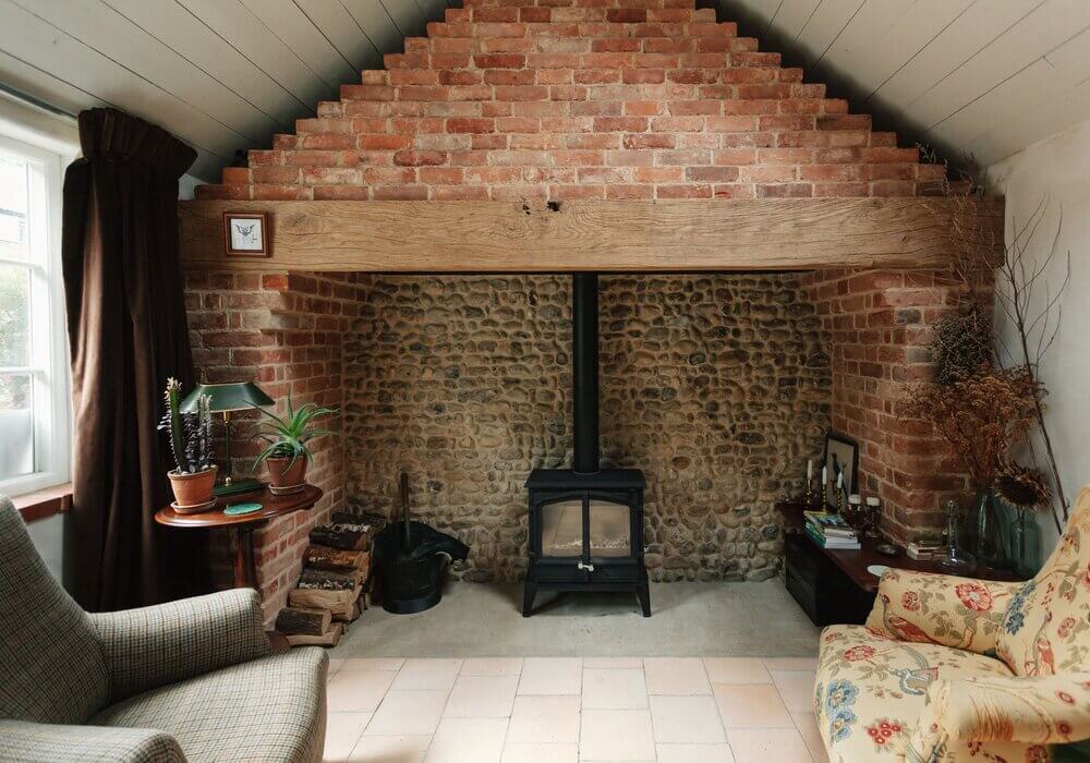 Spinks Nest: A Small Vintage Cottage in England 13 sitting-room-sloped-ceiling-stone-fireplace-nordroom