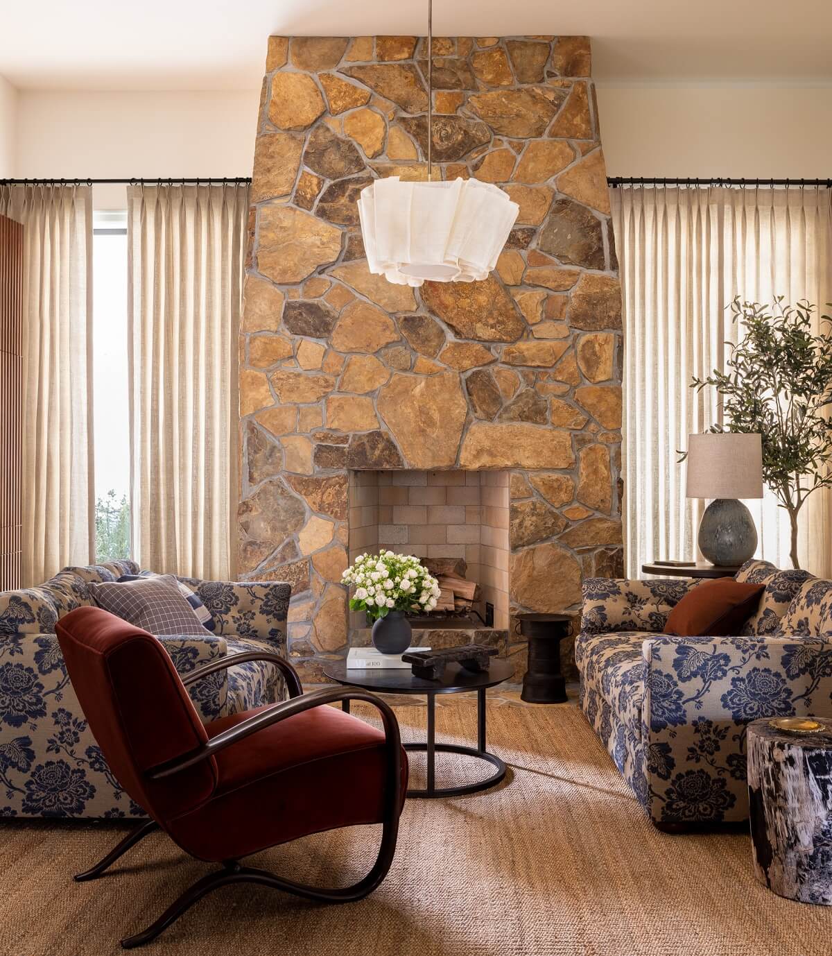 50+ Rooms That Prove ‘The Unexpected Red Theory’ Really Works 54 sitting-room-stone-fireplace-blue-patterned-sofas-red-armchair-nordroom