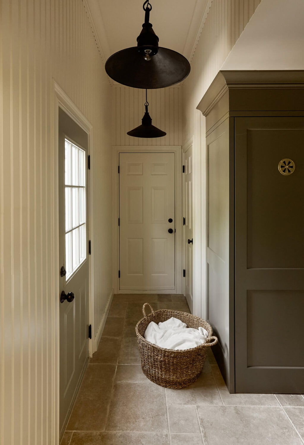 A Bedford Colonial Decorated in Warm Neutrals 17 utility-room-stone-floor-built-in-cabinets-nordroom