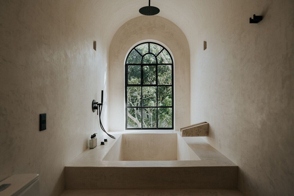 A Serene Apartment in Tulum with High Ceilings and Rooftop Pool 22 arched-window-bath-serene-natural-materials-nordroom