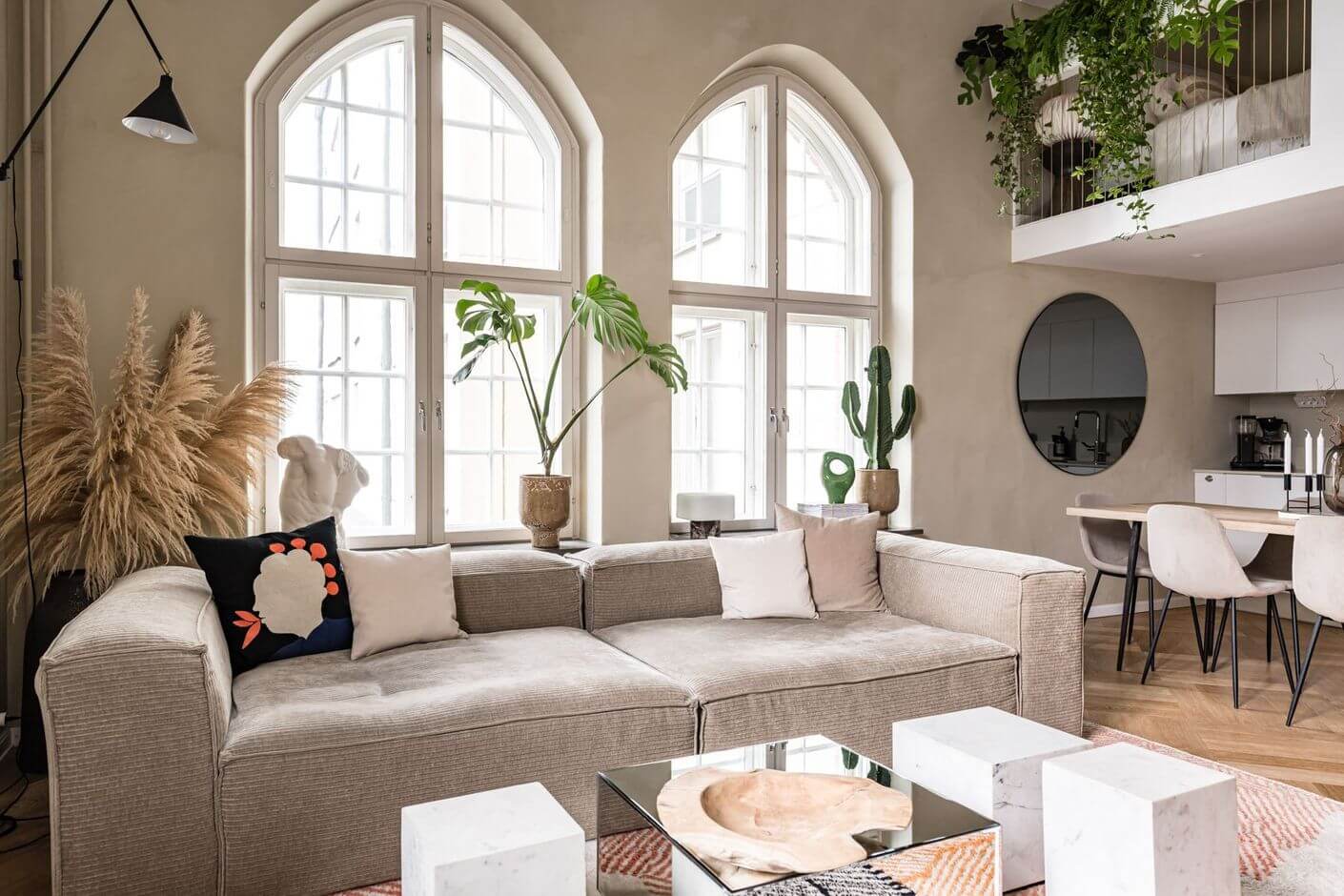 A Historic Factory Transformed Into A Stylish Home 6 arched-windows-loft-living-room-gray-sofa-nordroom