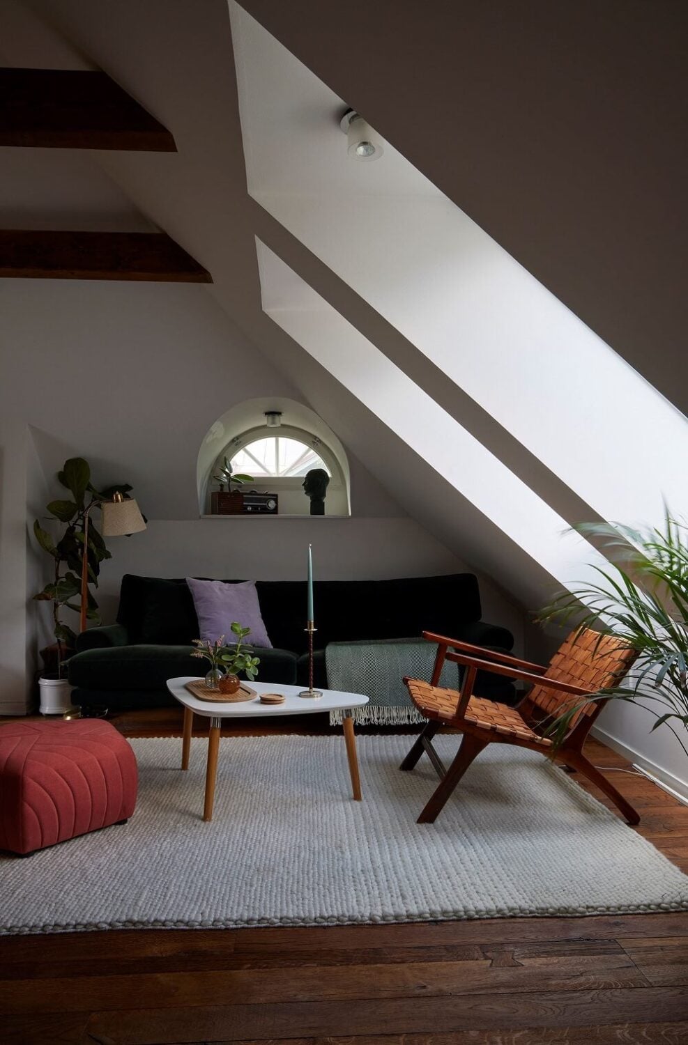 A Split-Level Attic Apartment with Blue Bedroom 8 attic-living-room-wooden-beams-velvet-sofa-nordroom