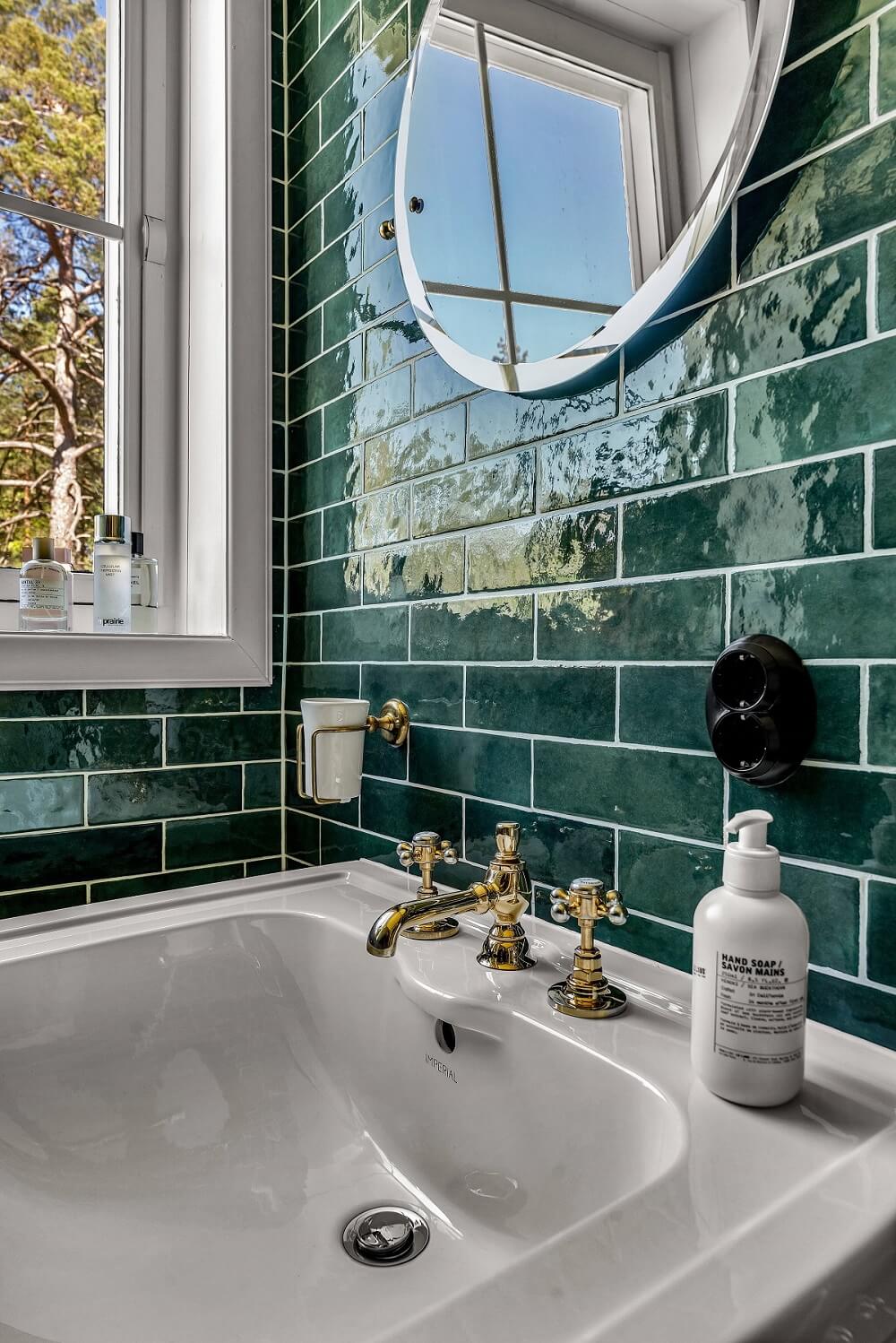 Bold Colors in a 1920s Villa in Sweden 18 bathroom-glossy-green-tiles-round-mirror-nordroom