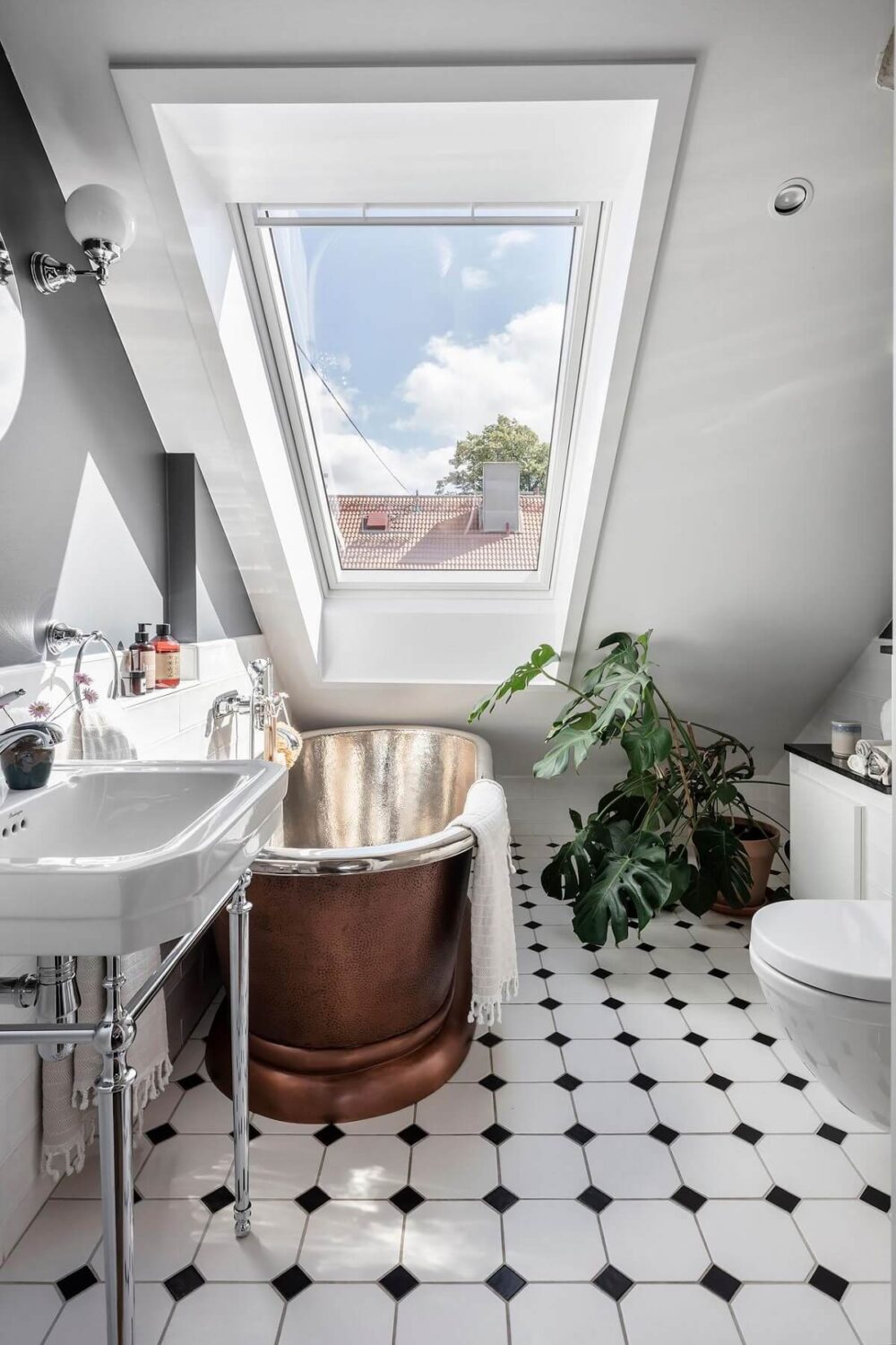 A Swedish Maisonette with Warm Pink Living Room 16 bathroom-sloped-ceiling-copper-bath-nordroom