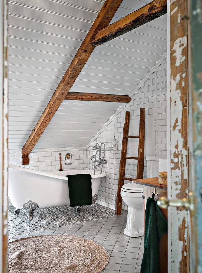 A Charming Swedish Villa Filled with Wallpaper 19 bathroom-wooden-beams-subway-tiles-clawfoot-tub-nordroom