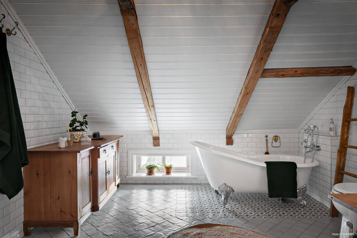 A Charming Swedish Villa Filled with Wallpaper 18 bedroom-sloped-ceiling-exposed-beams-clawfoot-bath-nordroom
